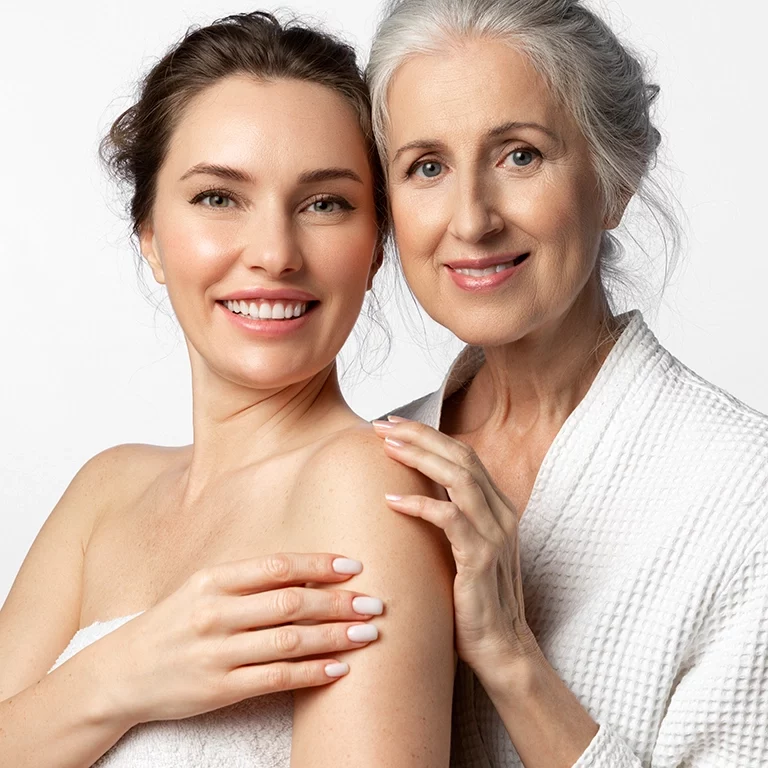 Two tender beautiful women of different ages and generations together on a white background