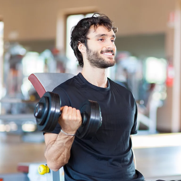 man working out in gym lifting weights